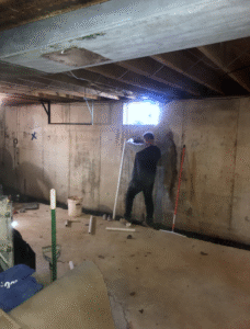 Crew waterproofing a basement in York PA