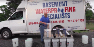 Our crew setting up an interior drainage system for a basement waterproofing job in Freehold NJ