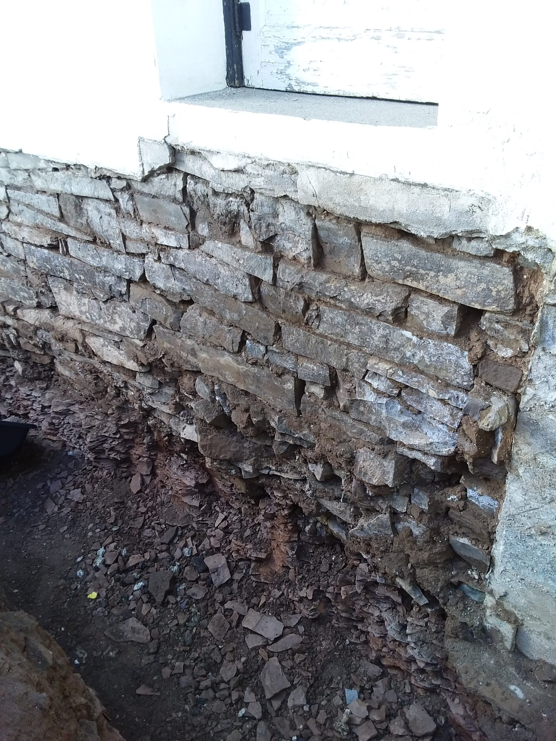 Exterior of a basement waterproofing in Long Branch NJ. Fixing the external problem.