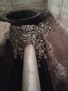 Wide drainage trench part of a basement waterproofing system in Milton PA.