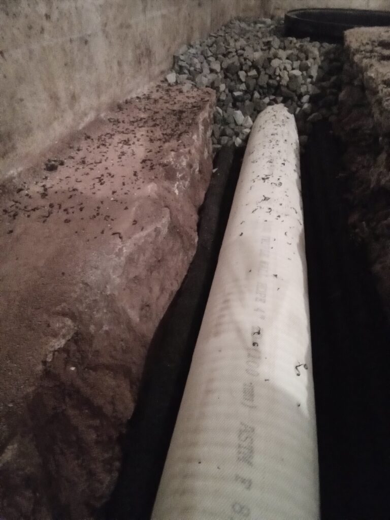 Large drain pipe as part of this basement waterproofing system in Adams County PA.